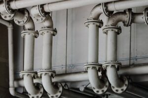 Grayscale industrial metal pipes - Kitec plumbing pipes found in Oakville homes built 1995 to 2007